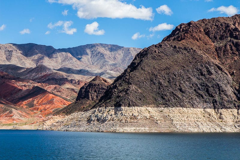 colored mountains beside lake