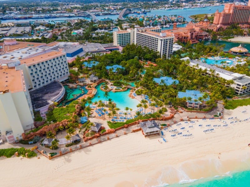 25 Things to Do in the Bahamas & Places to Visit 1 The Coral Hotel at Atlantis Resort aerial view with Nassau downtown at the background on Paradise Island, Bahamas