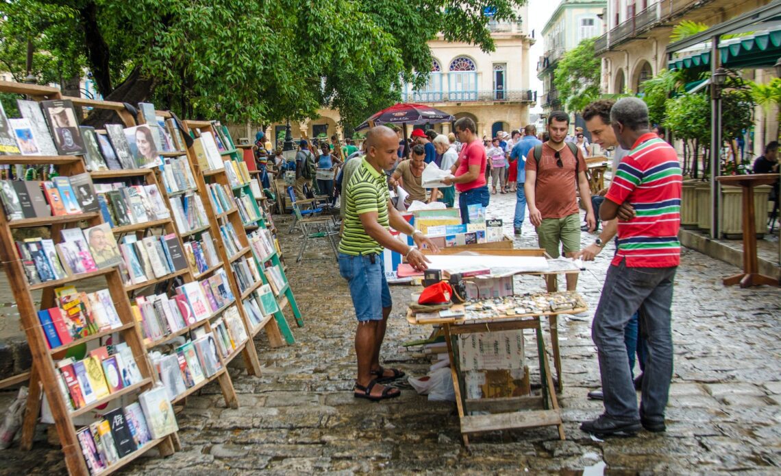 ourists examine a poster at one of the stalls at Plaza de Armas selling books, magazines, art and antiques.