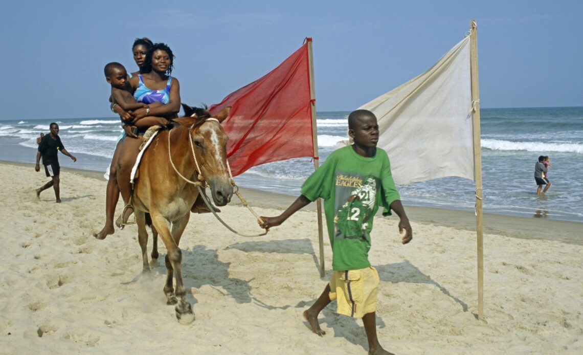 Families enjoying the sand at Labadi Beach in Accra