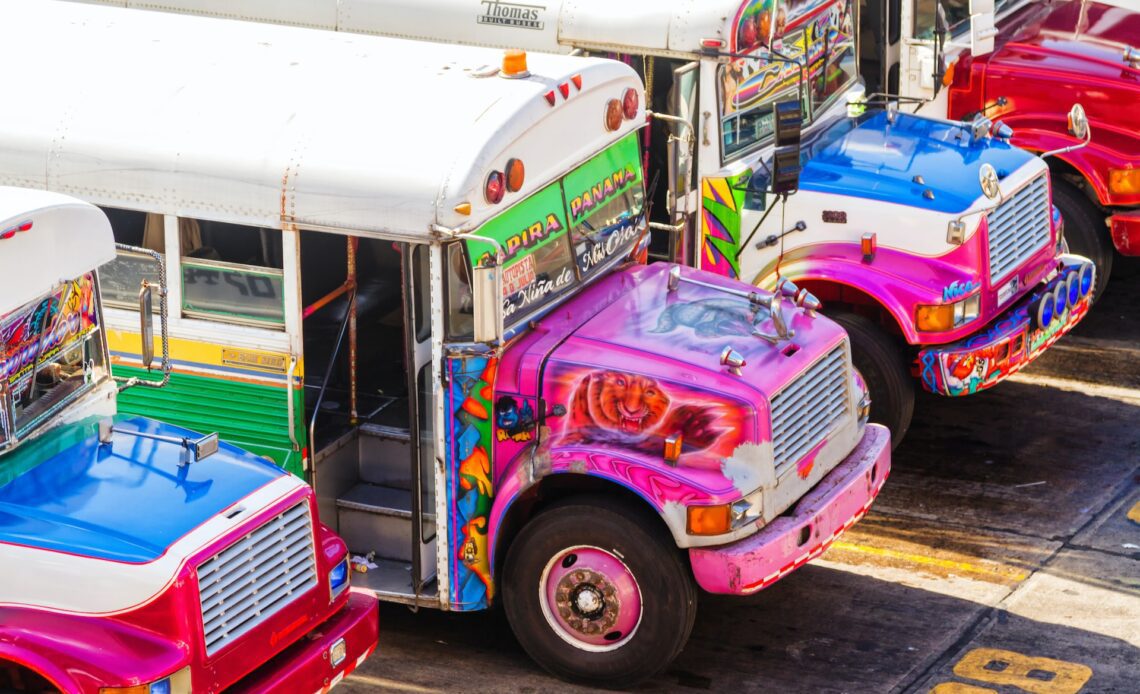 Vividly colorful chicken buses waiting for passengers in Panama