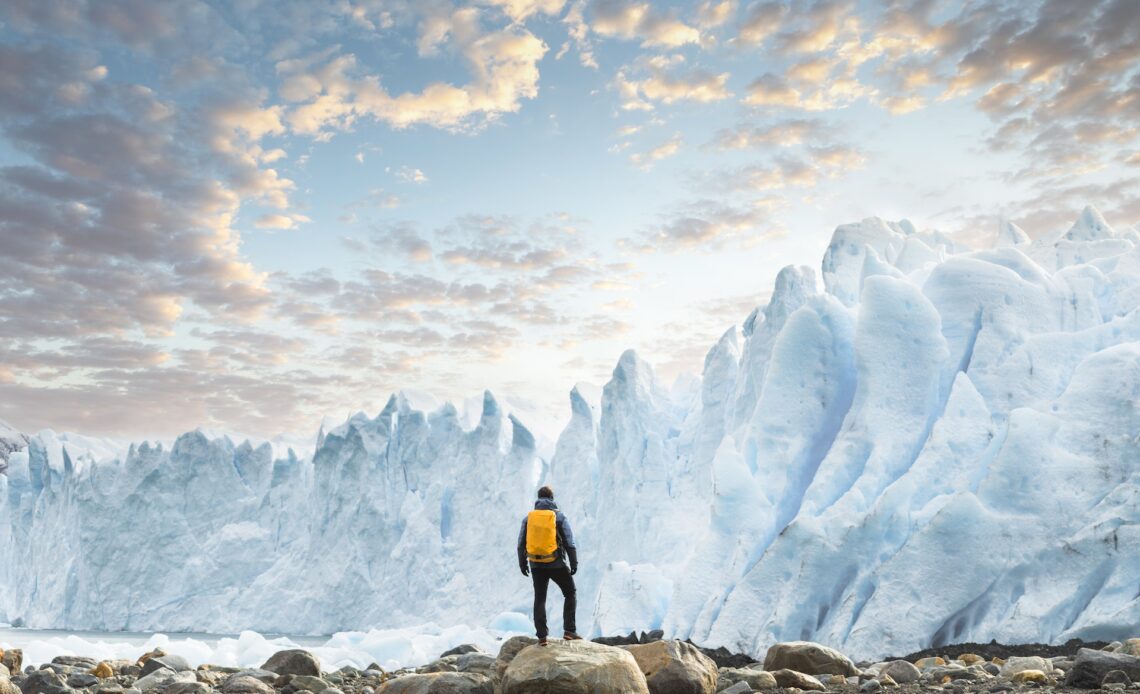 Hiker admiring the Perito Moreno glacier at sunset, Argentina