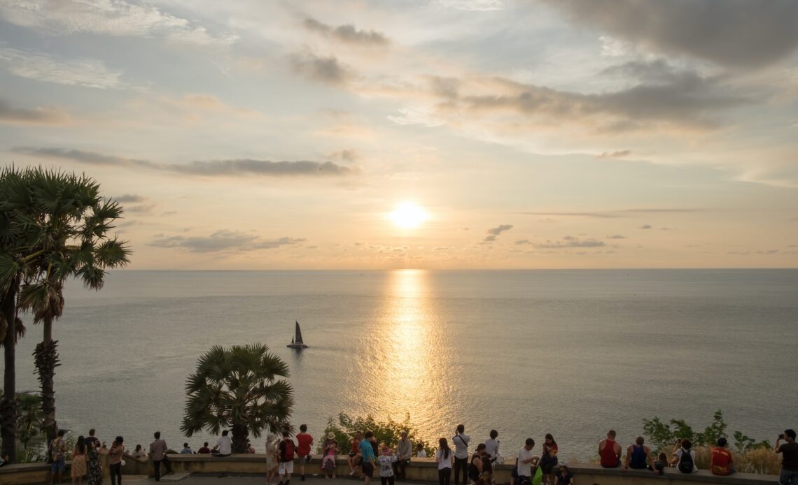 Tourists gather to watch the sunset on the Arabian Sea, Laem Phromthep, Phuket, Thailand