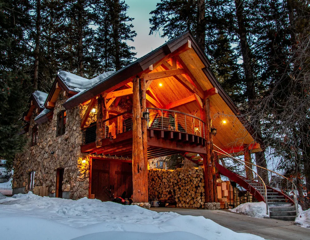 Outside of a cabin at dusk with snow