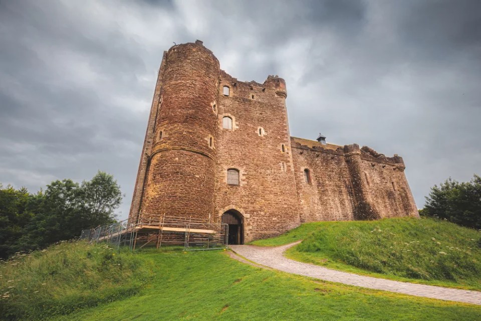 Historic 14th century medieval Doune Castle, with a dark, moody, dramatic sky in Perthshire, Scotland.