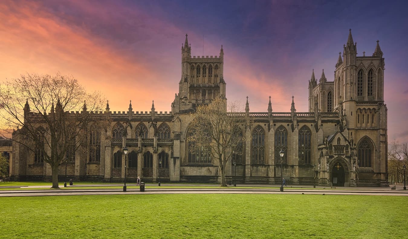 The historic exterior of the Bristol Cathedral in Bristol, UK during sunset