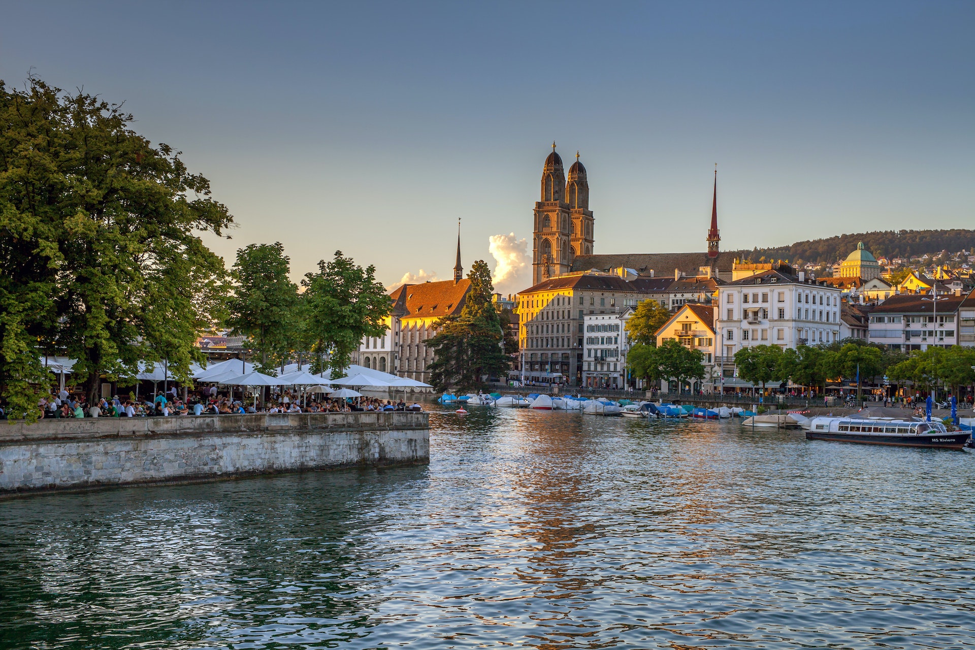 Iconic view of central Zurich on a warm summer evening. Main city sights including the FraumÃnster Church.(Kirche FraumÃnster) and Grossminster cathedral are seen on the banks of the Limmat River.