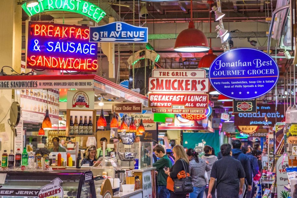 Vendors and customers in Reading Terminal Market. The historic market is a popular attraction for culinary treats.