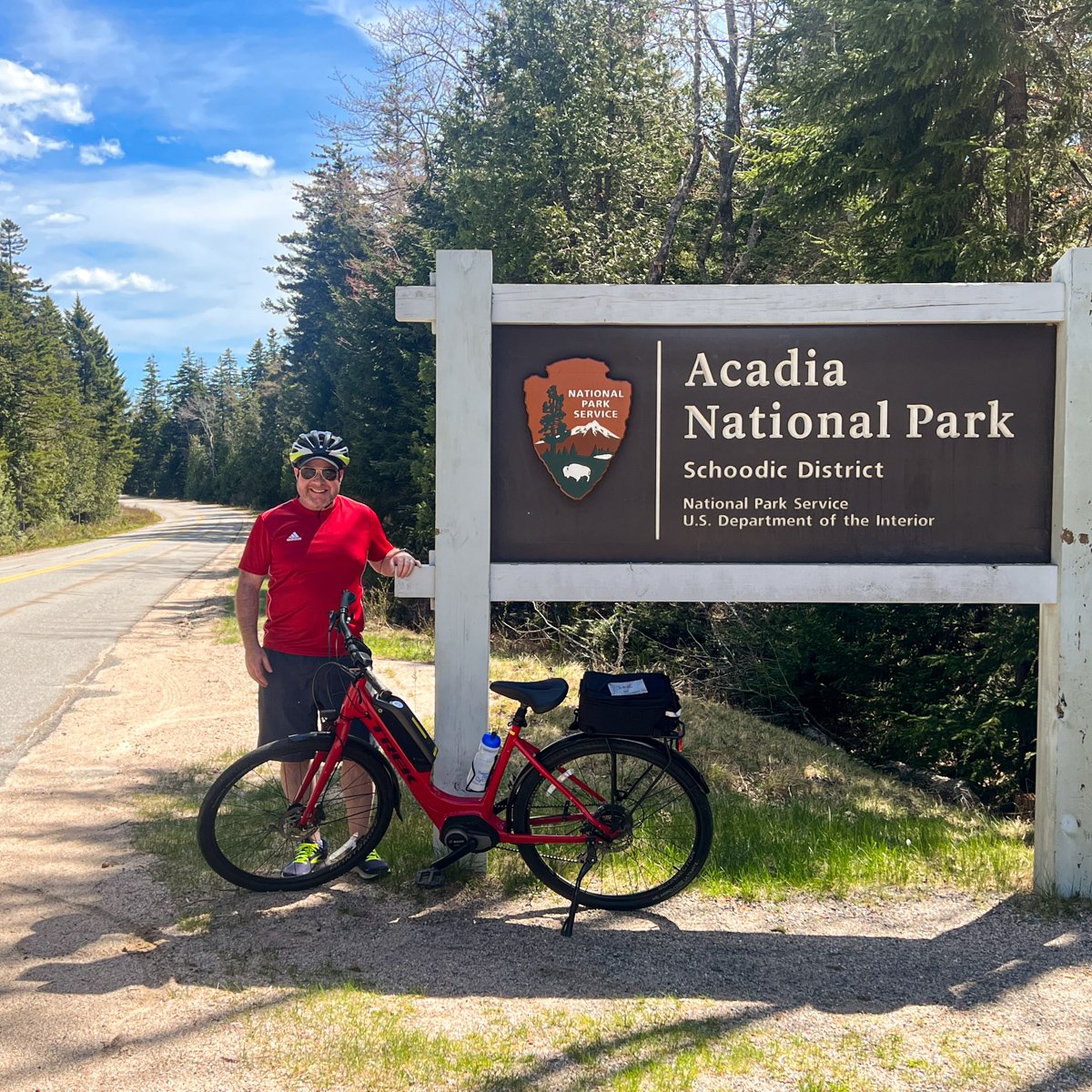 Dave with a Trek e-bike at the entrance sign to the Schoodic District in Acadia National Park, Maine