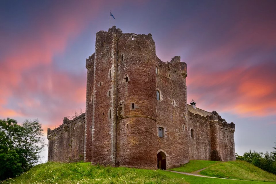Sunset over Doune Castle in the Stirling district, Scotland. It is a medieval courtyard fortress built around 1400 by Robert Stewart, Duke of Albany, Regent of Scotland.