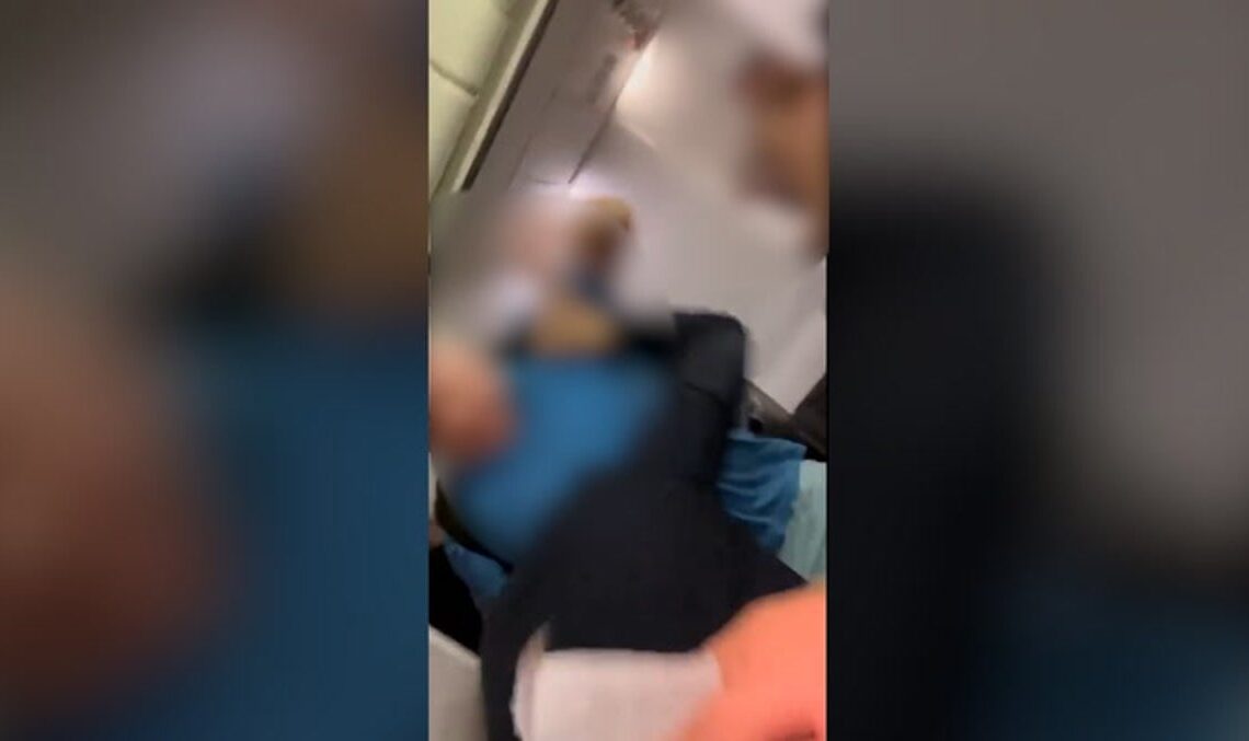 Passenger attempts to punch flight attendant and jump out of plane emergency exit