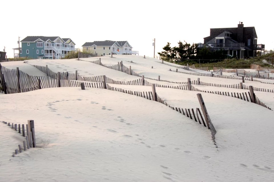Seasonal and vacation homes are built in the dunes along the Outer Banks of North Carolina.