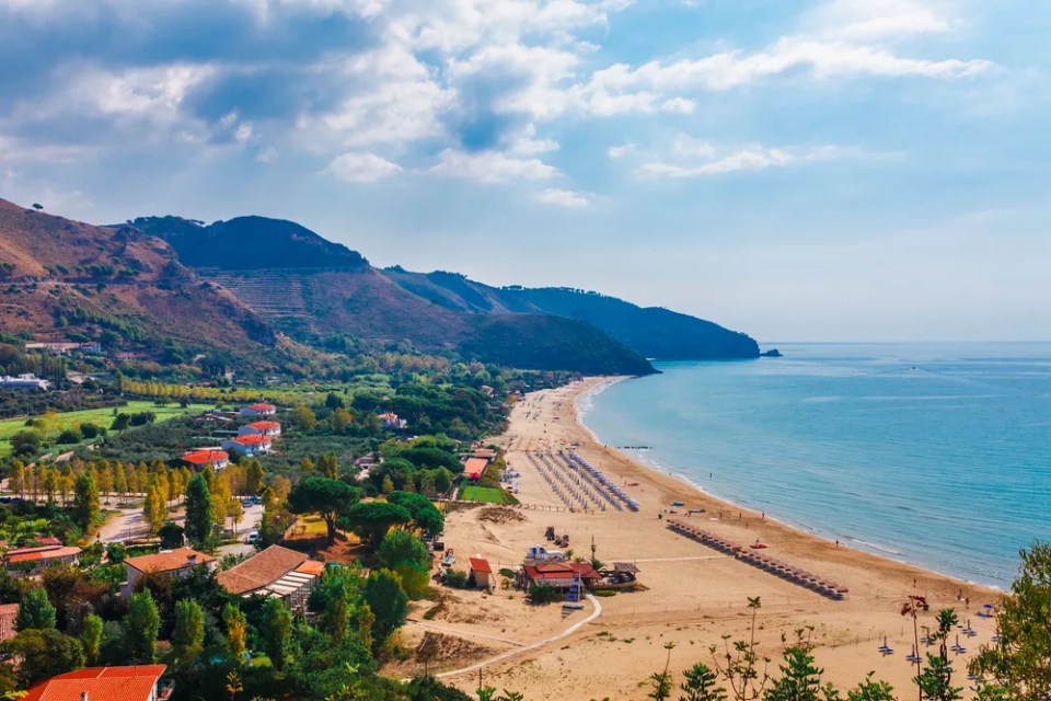 Beach and sea landscape with Sperlonga, Lazio, Italy. Scenic resort town village with nice sand beach and clear blue water in picturesque bay. Famous tourist destination in Riviera de Ulisse