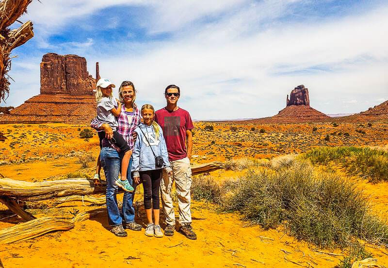 makepeace family standing in front of the mittens at monument valley