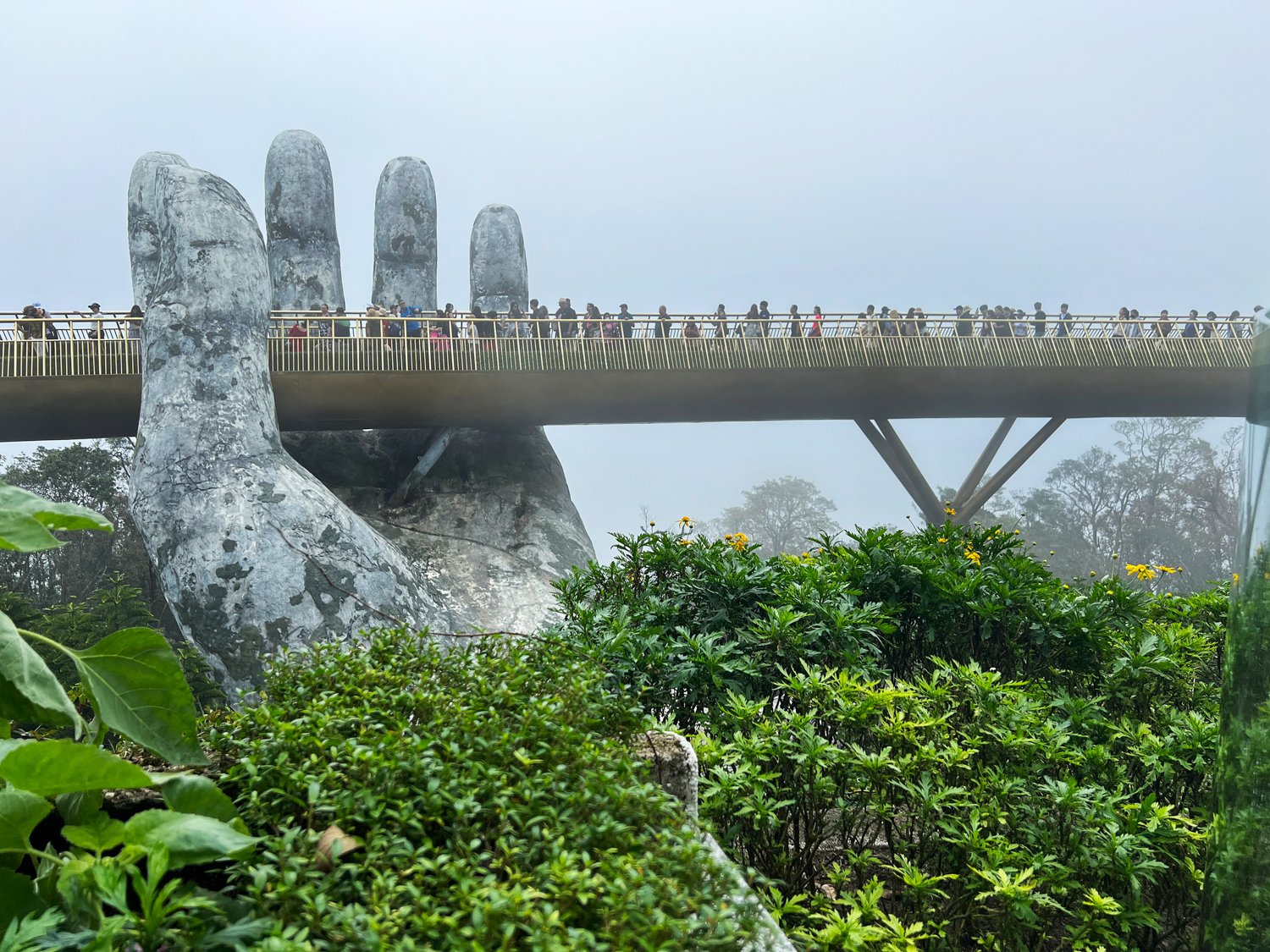 The weathered hands give the bridge an aged, ancient feel.