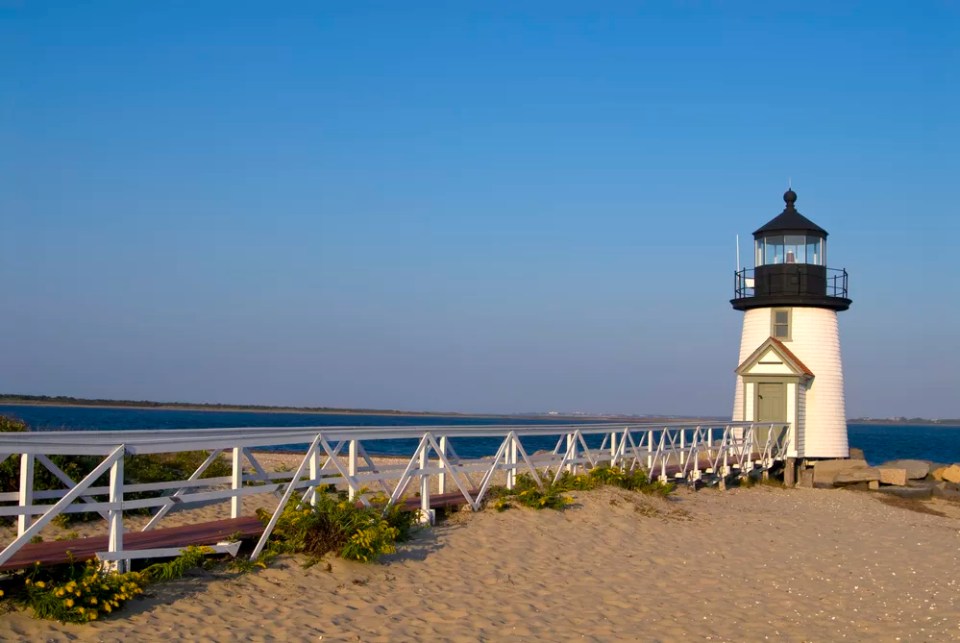 Walkway leads to Brant Point lighthouse, a famous beacon on Nantucket Island in Massachusetts.