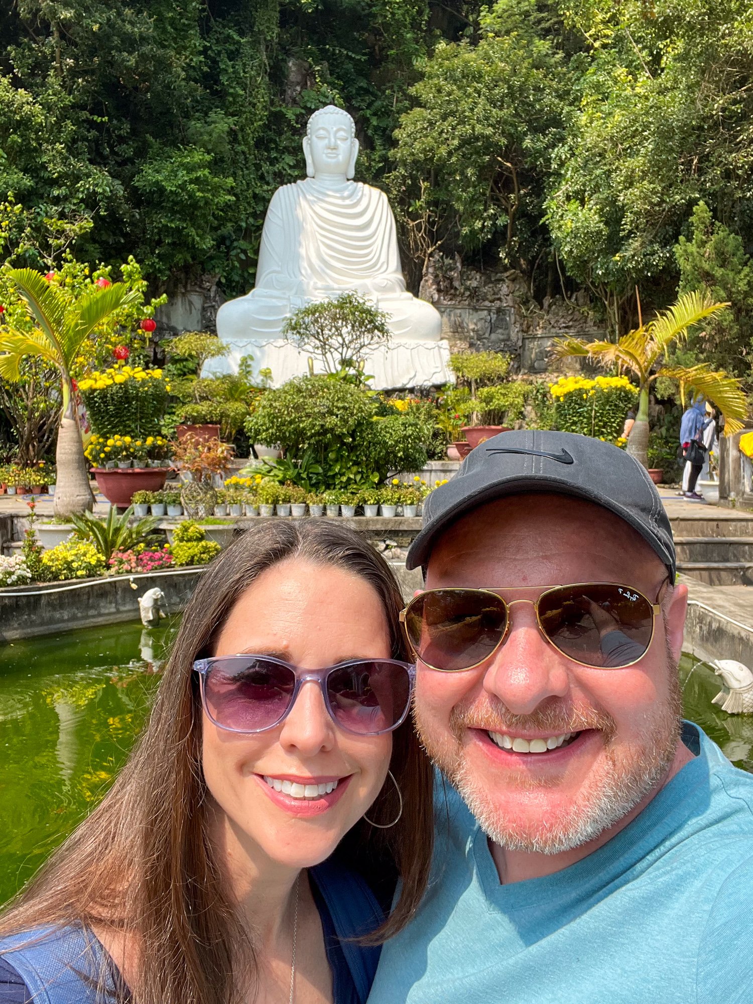 Kel and Dave take a selfie in front of the giant seated Buddha statue at Marble Mountains in Vietnam.