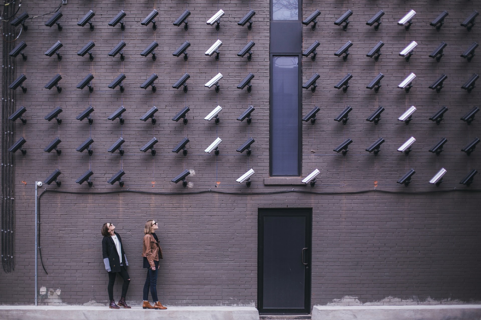 Women look at security cameras, a commentary on privacy concerns in the modern era. (photo: Matthew Henry)