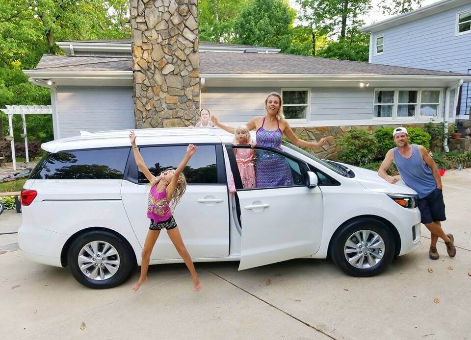 makepeace family jumping beside mini van