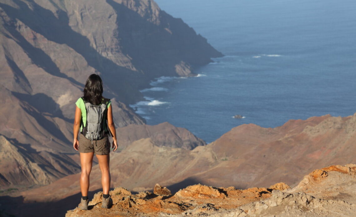 Woman hiking on top volcanic craters on St Helena