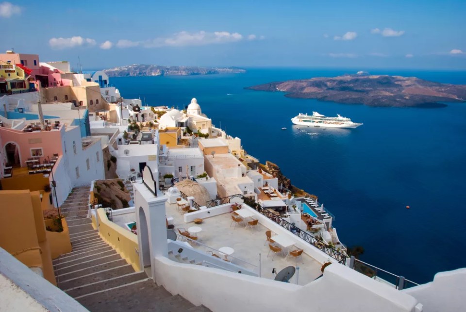 The island of Santorini. Morning view of the harbor, the volcano and Thira