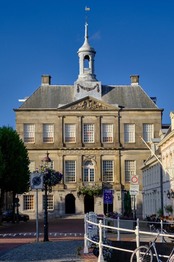 Town hall (Stadhuis)  and Weesp Museumagainst a clear blue sky.