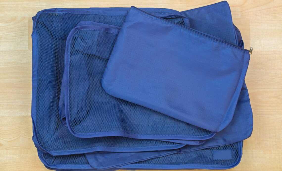 Different blue cube bags, set of travel organizer to help packing luggage easy, well organized