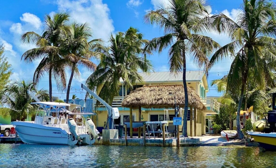 Waterfront cabin in Key Largo, Florida Keys surrounded by water and palm trees