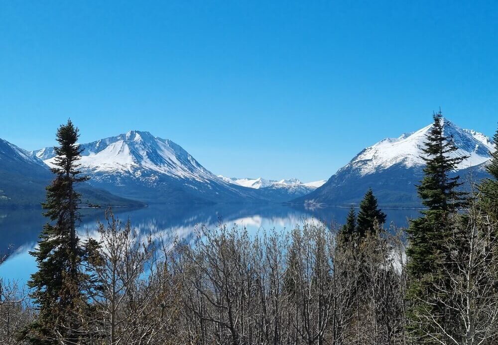 snow capped mountains beside a lake