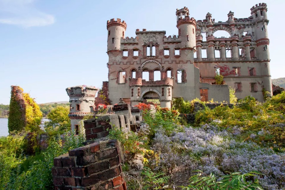 Bannerman castle armory ruins with overgrown garden flowers