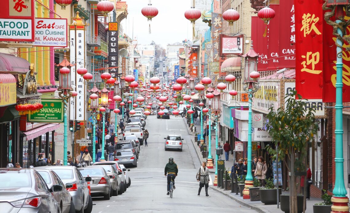 A December day on Grant Avenue, the main street in San Francisco's Chinatown. A man bicycles down Grant Street in Chinatown.