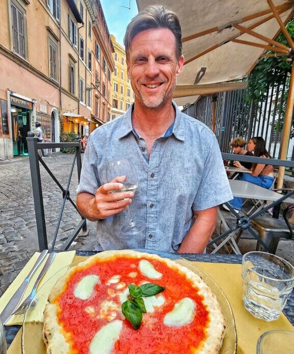 craig eating pizza and drinking wine