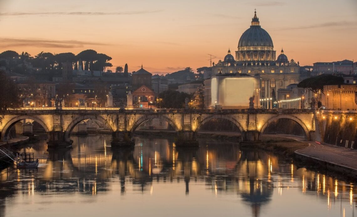 St. Peter's Basilica, Saint Angelo Bridge and Tiber River in the sunset.