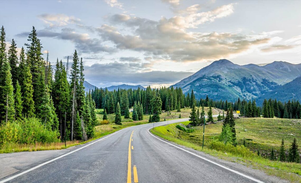 The wide open road on a road trip through a beautiful natural landscape abroad