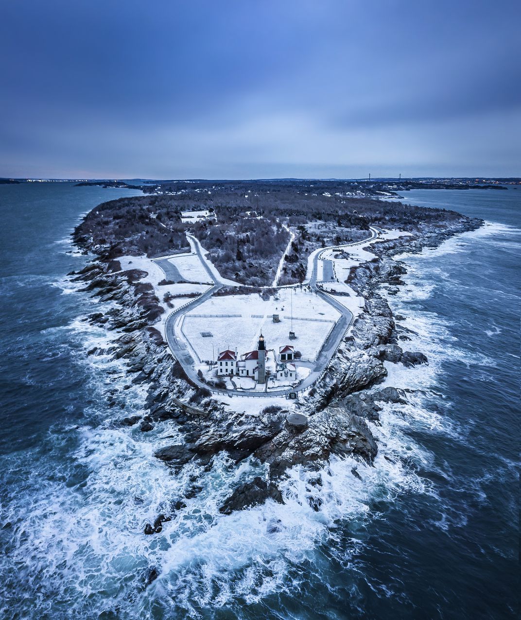 10 - Snow covers the grounds of Beavertail Lighthouse, which sits at the end of Conanicut Island on Narragansett Bay.
