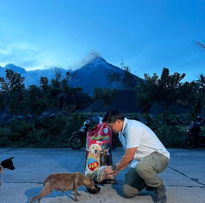 Doc Nielsen Donato feeds Top Breed to dogs in Albay, Bicol.