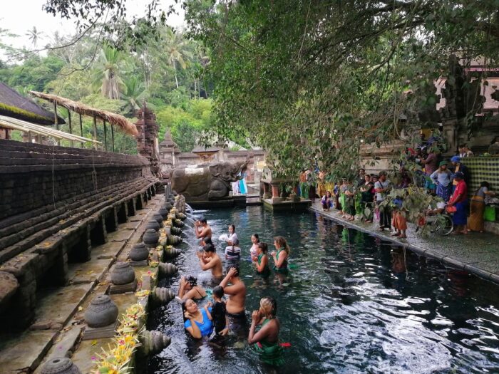 People participating in the bathing ritual in Tirta Empul Temple