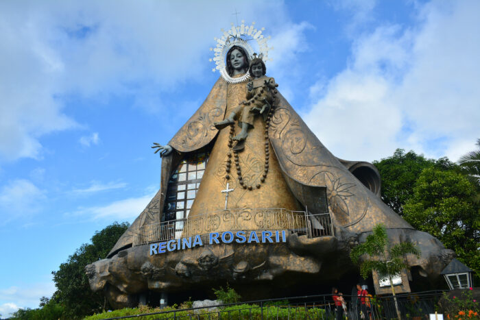 Regina Rica Rosarii statue facade photo via Depositphotos