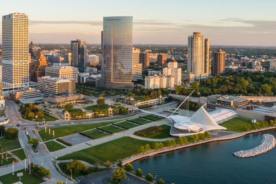 Milwaukee, WI - 3 September 2020:  Image from a drone of the Milwaukee skyline from lake Michigan during sunrise including US Bank, Milwaukee Art Museum and Northwestern Mutual buildings