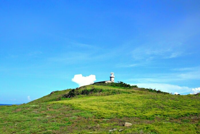 Lighthouse on top of the rolling hills in San Bernardino Island in Sorsogon by Ron Camara