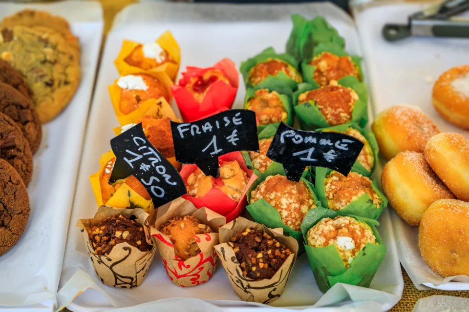 Freshly baked mini muffins with strawberry, lemon and apple at an artisanal bakery in Cours Saleya market in Old Town, Vieille Ville in Nice, France