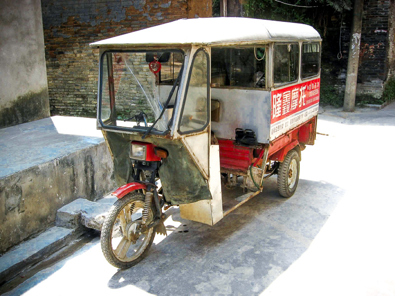 old chinese tuk tum by the side of hte road