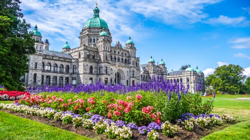 a flower garden in front of a builidng