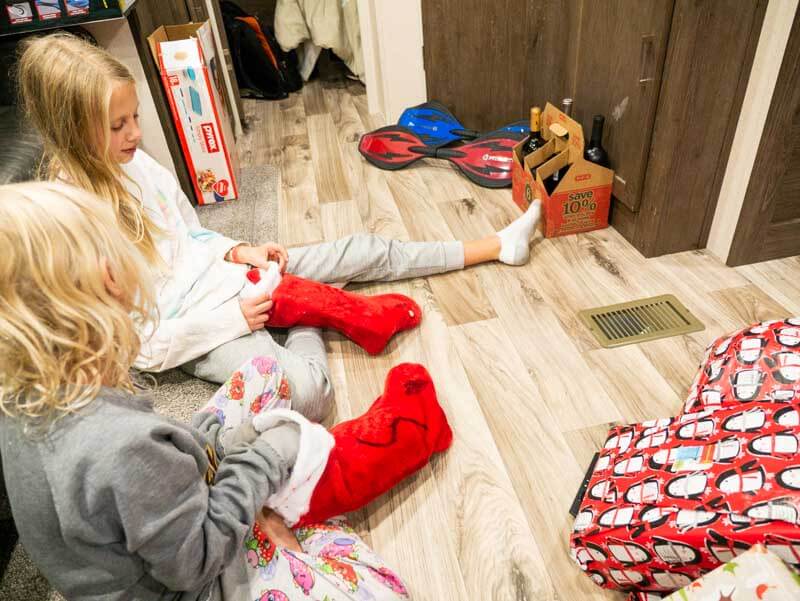 girls sitting on the floor holding presents