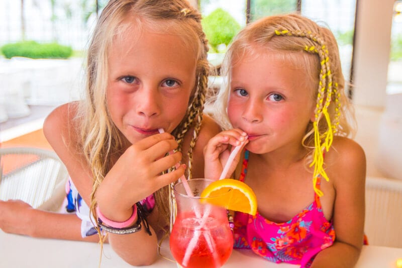 girls drinking through straws