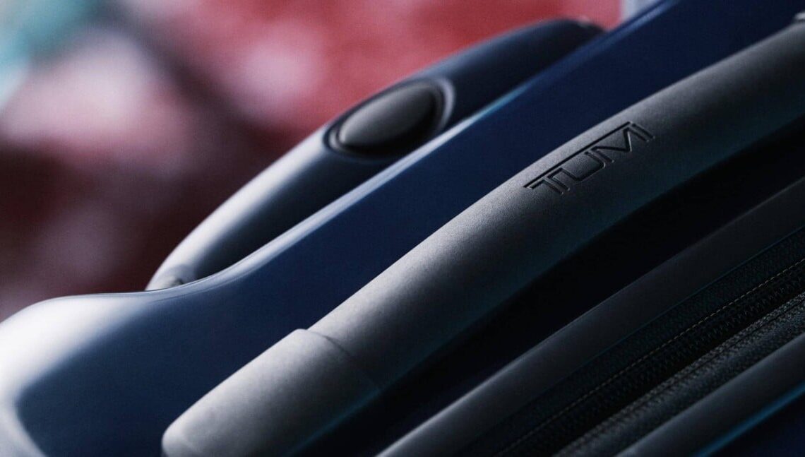 An up-close view of a dark blue TUMI suitcase