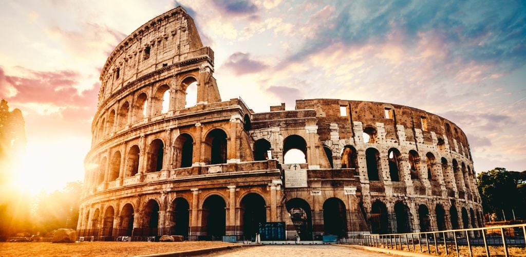 The ancient Colosseum in Rome at sunset.