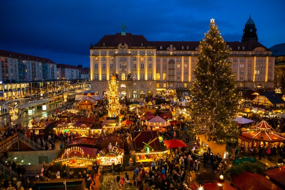 People visit Christmas Market Striezelmarkt in Dresden, Germany. Christmas fair.