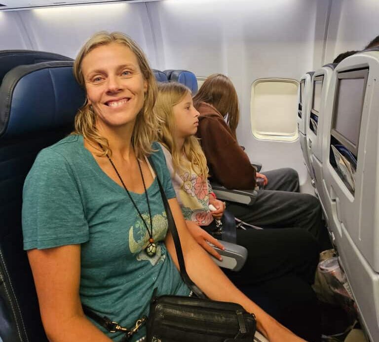 Mom and two daughters on a plane