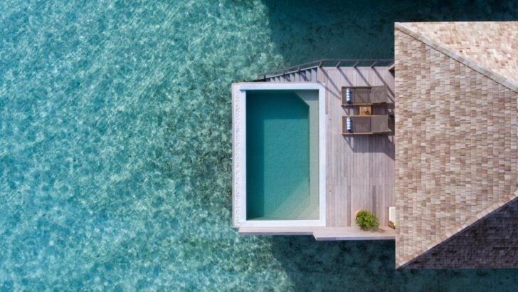 Aerial view of an overwater bungalow at Hurawalhi Island Resort in the Maldives